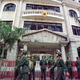 Chinese police stand guard on May 10, 1999 outside the German consulate in Guangzhou which was damaged in a protest against the NATO bombing on the Chinese embassy in Belgrade.
